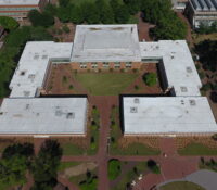 Zoomed Out Aerial View of Brick Building Academic Complex