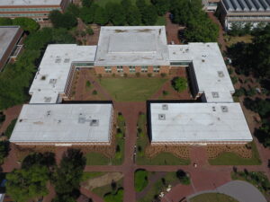 Zoomed Out Aerial View of Brick Building Academic Complex