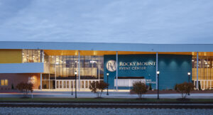 Rocky Mount Event Center Main Entrance with Lights at Dusk