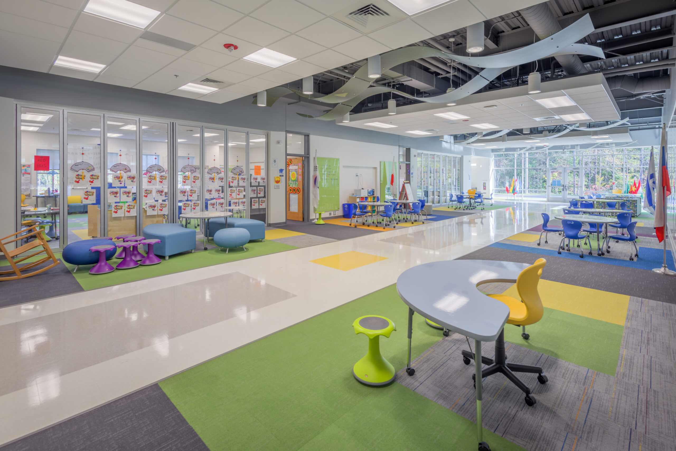 Barton Pond Elementary School Flex Space with Tables, Chairs, Ottomans, and Gathering Areas