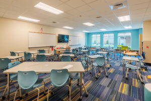 Neuse River Middle School Classroom with Tables and Blue Chairs