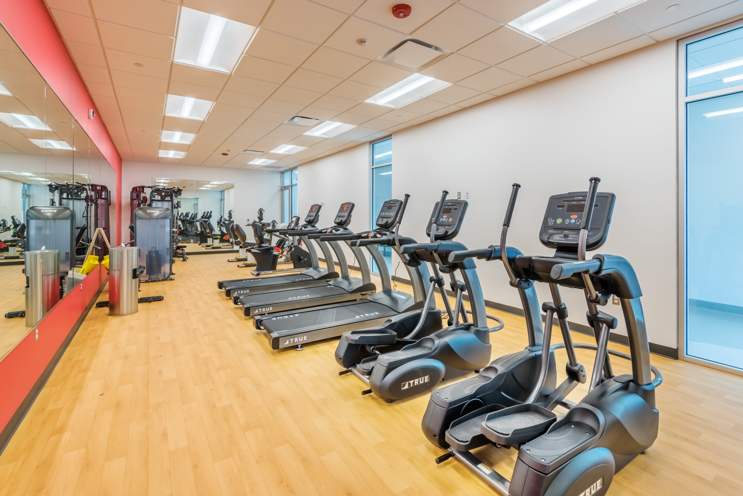 Apex Senior Center Fitness Room with Ellipticals, Treadmills, and Large Wall Mirrors