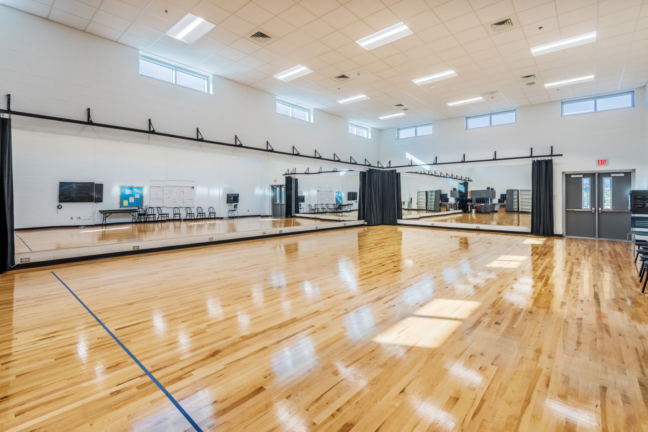 Fuquay-Varina High School Dance Studio with Large Wall Mirrors and Hardwood Floors