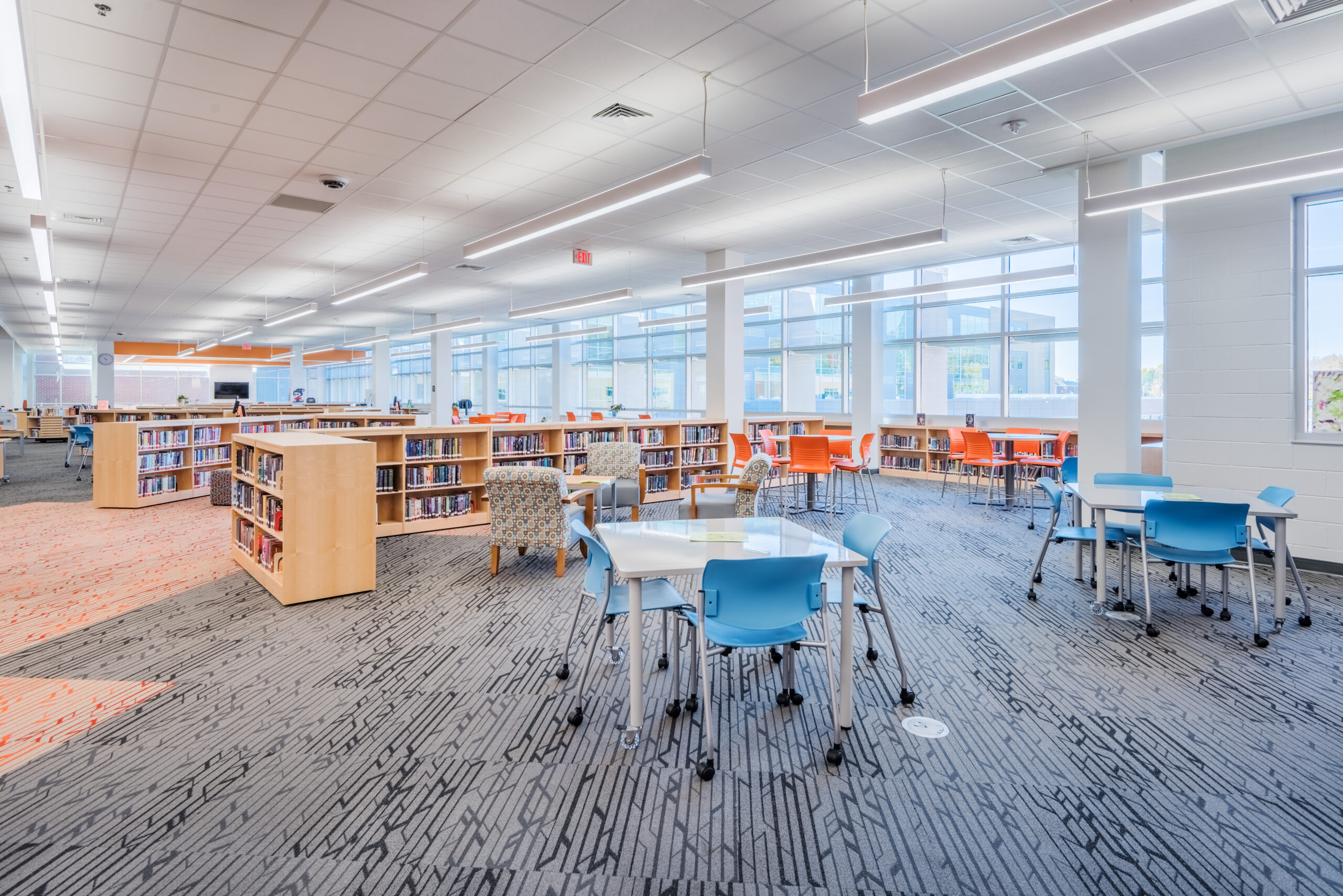 Fuquay-Varina High School Library Open Seating Areas Surrounded by Full, Half-Height Book Shelves