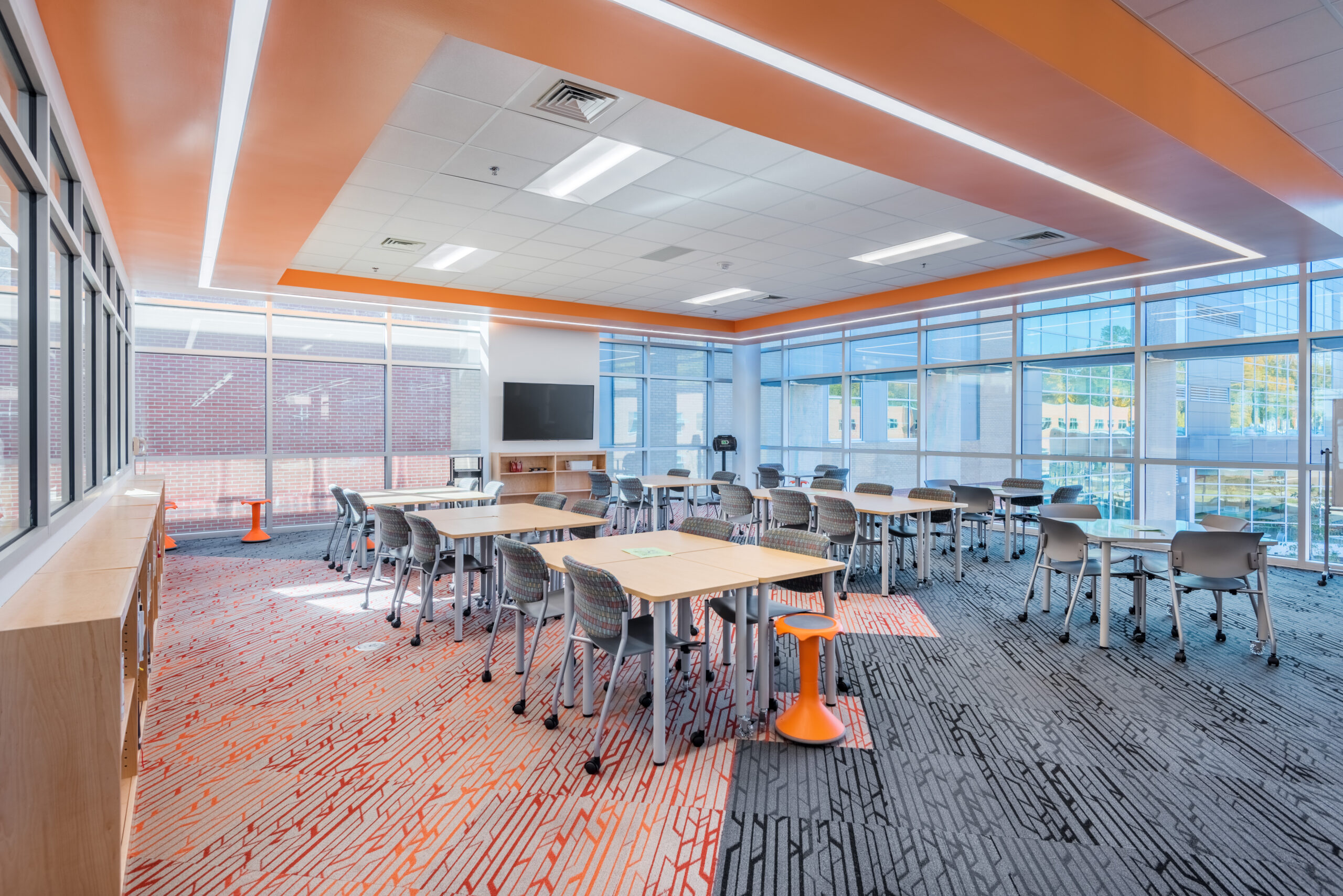 Fuquay-Varina High School Study Area with Orange Ceiling Decor and Floor to Ceiling Windows