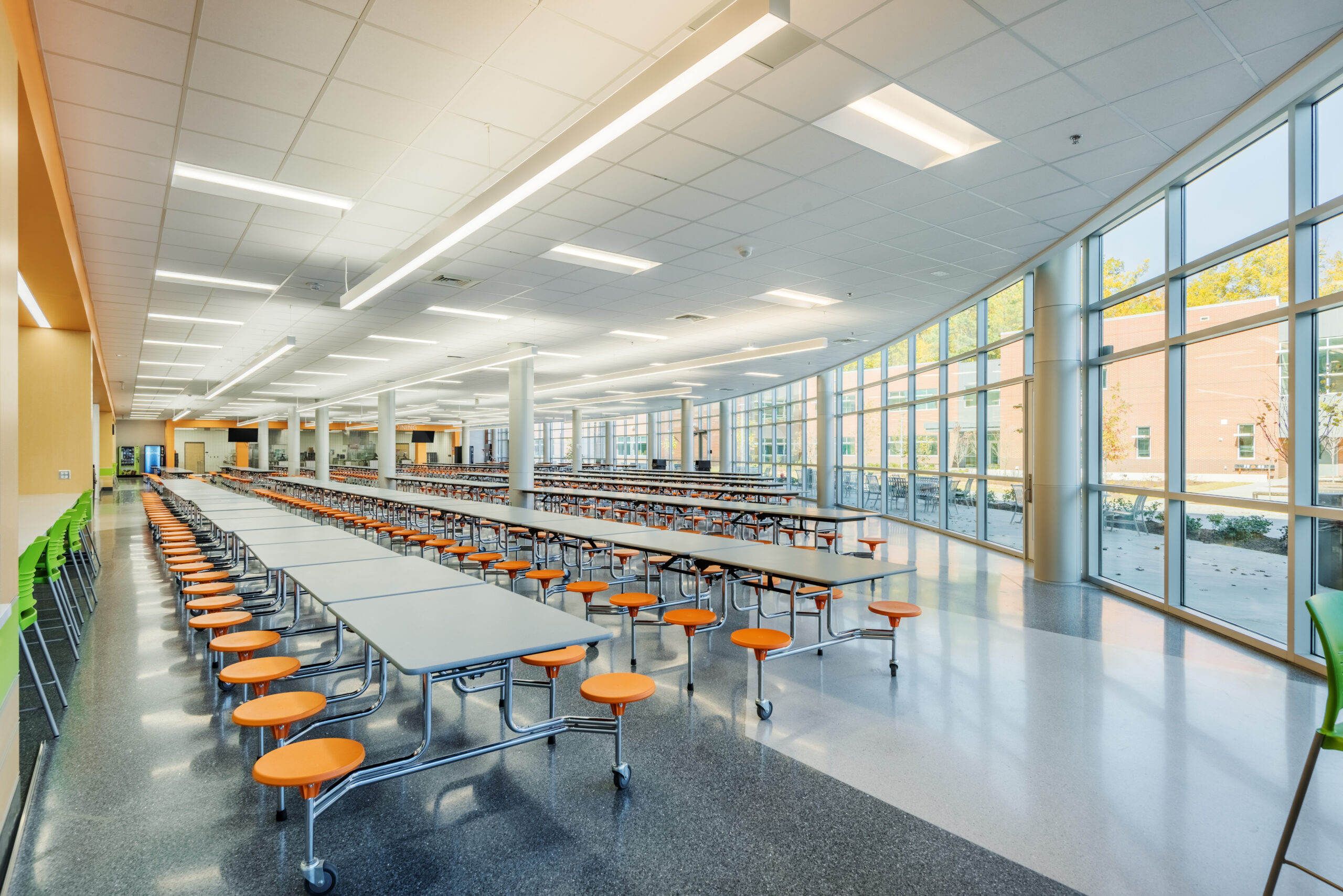 Fuquay-Varina High School Cafeteria with Telescoping Lunch Tables and Colorful Stools